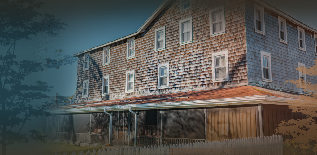 an old house with a red roof and brown shingles